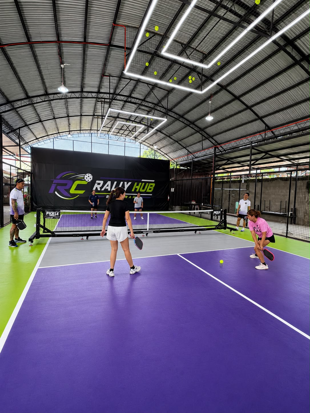 Net-level view of the empty RC Rally Hub pickleball court